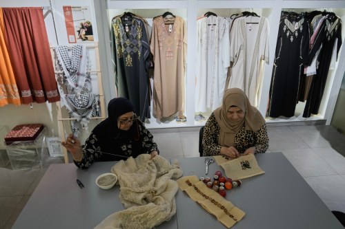 Palestinian weavers Rula Barakeh, right, and Samira Nasser work on handmade embroidered pieces at the Inaash Association embroidery workshop in Beirut, Tuesday, May 19, 2026. (AP Photo/Bilal Hussein)