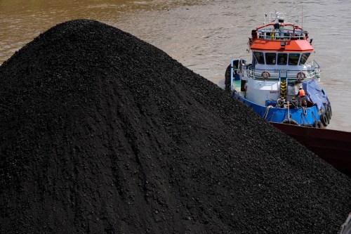 FILE - A tug boat pushes a barge carrying coal on Mahakam river in Samarinda, East Kalimantan, Indonesia, Dec. 19, 2022. (AP Photo/Dita Alangkara, File)