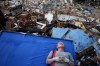 Resident Kerli Faria takes a break amid the rubble while searching for her nephews at a building that collapsed during the earthquakes that struck La Guaira, Venezuela, Tuesday, June 30, 2026. (AP Photo/Ariana Cubillos)