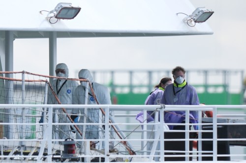 A crew in protective gear works on the MV Hondius cruise ship after its arrival at the Port of Rotterdam, Netherlands, Monday, May 18, 2026. (AP Photo/Patrick Post)