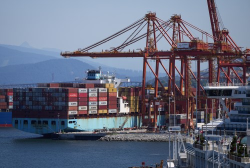 A gantry crane operator removes a container from a cargo ship while docked at port, in Vancouver, on Tuesday, July 16, 2024. THE CANADIAN PRESS/Darryl Dyck
