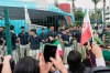 Fans greet members of the Iran World Cup soccer team as they leave their hotel for the airport Tuesday, June 30, 2026, in Tijuana, Mexico. (AP Photo/Gregory Bull)