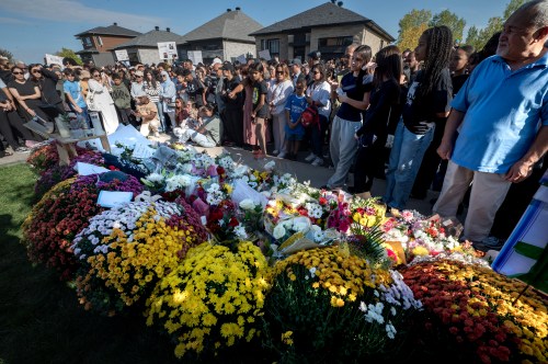 Hundreds of people pass by a memorial for Nooran Rezayi, in Longueuil, Que., Saturday, Sept. 27, 2025. Rezayi, a 15-year-old boy, was shot dead after officers responded to a 911 call about a group of armed young people in a public place in Longueuil. THE CANADIAN PRESS/Peter McCabe