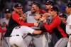 Washington Nationals' Andrés Chaparro, center, is held back as tempers flare during the fourth inning of a baseball game against the Boston Red Sox, Tuesday, June 30, 2026, in Boston. (AP Photo/Charles Krupa)