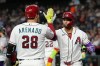 Arizona Diamondbacks' Lourdes Gurriel Jr., right, celebrates his three-run home run against the San Francisco Giants with Diamondbacks' Nolan Arenado (28) during the first inning of a baseball game, Tuesday, June 30, 2026, in Phoenix. (AP Photo/Ross D. Franklin)