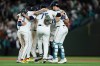 The Seattle Mariners celebrate after defeating the Los Angeles Angels in a baseball game Tuesday, June 30, 2026, in Seattle. (AP Photo/Kevin Ng)