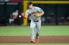 San Francisco Giants third baseman Matt Chapman makes a one-handed grab on a grounder hit by Arizona Diamondbacks' Gabriel Moreno (14) before throwing to first base for the out during the sixth inning of a baseball game, Tuesday, June 30, 2026, in Phoenix. (AP Photo/Ross D. Franklin)