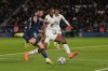 FILE - Rennes' Jeremy Jacquet, centre, challenges with PSG's Joao Neves during the French League One soccer match between Paris and Rennes in Paris, France, on Dec. 6, 2025. (AP Photo/Thibault Camus, File)
