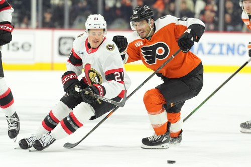 Ottawa Senators' Nick Cousins (21) and Philadelphia Flyers' Garnet Hathaway (19) vie for the puck during the first period of an NHL hockey game, Thursday, Feb. 5, 2026, in Philadelphia. (AP Photo/Matt Rourke)