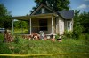 Police tape surrounds a home where authorities say they removed 16 children and arrested four adults in Hamden, Ohio, Wednesday, July 1, 2026. (AP Photo/Carolyn Kaster)