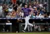 Colorado Rockies' Mickey Moniak points up while rounding the bases on a home run in the first inning of a baseball game against the Miami Marlins Wednesday, July 1, 2026, in Denver. (AP Photo/Geneva Heffernan)