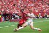 Canada's Luc de Fougerolles (4) takes the ball away from Switzerland's Johan Manzambi (9) during the first half of a World Cup Group B soccer match, in Vancouver, on Wednesday, June 24, 2026. THE CANADIAN PRESS/Darryl Dyck