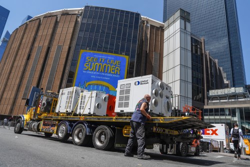 A worker unloads portable air-conditioning units outside of Madison Square Garden ahead of a reported wedding between singer Taylor Swift and National Football League player Travis Kelce on Thursday, July 2, 2026, in New York. (AP Photo/Ryan Murphy)