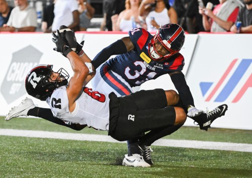 Ottawa Redblacks' Keelan White, left, makes a touchdown catch as Montreal Alouettes' Faion Hicks (31) defends during second half CFL football action in Montreal, on Sunday, June 28, 2026. THE CANADIAN PRESS/Graham Hughes