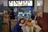 Gabriela Alves pets her dog, which she found alive a week after the earthquakes, at a McDonald’s restaurant being used as a temporary health center and pet reunification center in La Guaira, Venezuela, Thursday, July 2, 2026. (AP Photo/Matias Delacroix)