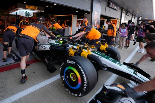 Mechanics push McLaren driver Lando Norris' car back into the team garage during the first free practice ahead of the British F1 Grand Prix, in Silverstone, England, Friday, July 3, 2026. (AP Photo/Darko Bandic)