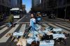 Dog walker Nahuel Meneghini walks dogs dressed in jerseys of the Argentine national soccer team in Buenos Aires, Argentina, Thursday, July 2, 2026. (AP Photo/Rodrigo Abd)