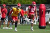 Kansas City Chiefs quarterback Patrick Mahomes (15) and tight end Travis Kelce (87) stretch out during the NFL football team's practice Tuesday, June 9, 2026, in Kansas City, Mo. (AP Photo/Ed Zurga)