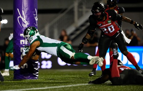 Saskatchewan Roughriders' KeeSean Johnson (3) scores a touchdown past Ottawa Redblacks' A.J. Allen (bottom right) during second half CFL football action in Ottawa on Friday, July 3, 2026. THE CANADIAN PRESS/Justin Tang