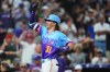 Colorado Rockies' Jake McCarthy gestures as he crosses home plate after hitting a grand slam off San Francisco Giants relief pitcher Matt Gage in the fifth inning of a baseball game Friday, July 3, 2026, in Denver. (AP Photo/David Zalubowski)