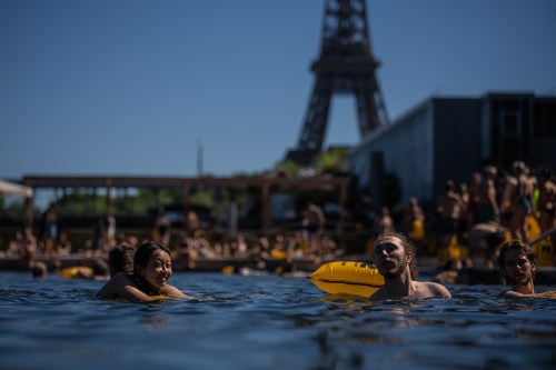 People swim in the Seine River, Saturday, July 4, 2026 in Paris. (AP Photo/Aurelien Morissard)