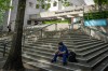 A hospital worker sits outside of the Vancouver General Hospital in Vancouver, B.C., on Tuesday, May 12, 2026. THE CANADIAN PRESS/Ethan Cairns