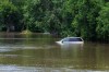 A van sits in flooded street in Swan River, Man., Thursday, July 2, 2026. THE CANADIAN PRESS/Mike Deal - POOL