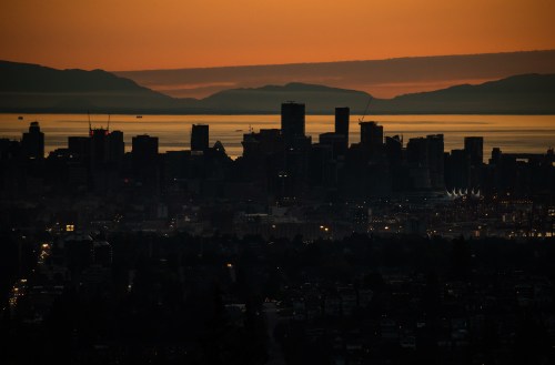 The downtown Vancouver skyline is silhouetted at sunset on Monday, July 11, 2022. THE CANADIAN PRESS/Darryl Dyck