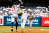New York Yankees' Jazz Chisholm Jr.(13) tries to avoid being tagged out by Minnesota Twins' Royce Lewis (23) during a rundown in the second inning of a baseball game, Sunday, July 5, 2026, in New York. (AP Photo/Noah K. Murray)