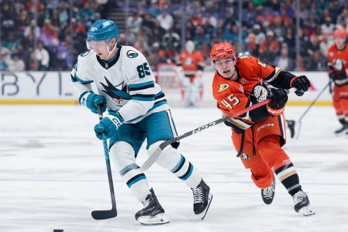 San Jose Sharks defenseman Shakir Mukhamadullin, left, and Anaheim Ducks right wing Beckett Sennecke (45) vie for the puck during the first period of an NHL hockey game Thursday, April 9, 2026, in Anaheim, Calif. (AP Photo/Ryan Sun)