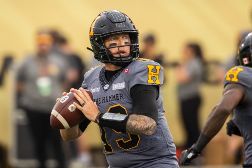Hamilton Tiger-Cats quarterback Bo Levi Mitchell (19) looks for a pass during first half CFL football action against the Winnipeg Blue Bombers, in Hamilton on Sunday, July 5, 2026. THE CANADIAN PRESS/Nick Iwanyshyn