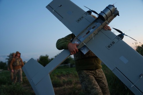 A Ukrainian serviceman of K-2 brigade of the Unmanned Systems Forces carries a midrange drone on takeoff position before flying towards Russian positions at the frontline in Donetsk region, Ukraine, Monday, June 22, 2026. (AP Photo/Evgeniy Maloletka)