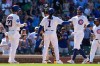 Chicago Cubs' Dansby Swanson, right, celebrates with Michael Conforto, left, and Justin Dean after hitting a grand slam during the eighth inning of a baseball game against the San Diego Padres in Chicago, Wednesday, July 1, 2026. (AP Photo/Nam Y. Huh)