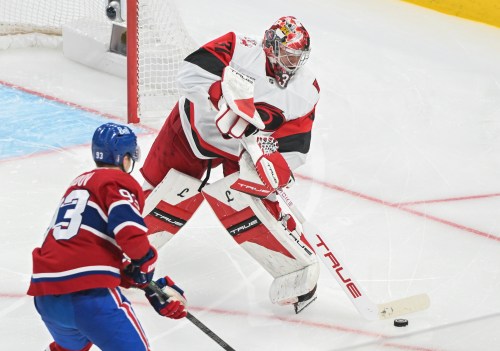 Carolina Hurricanes goaltender Frederik Andersen (31) clears the puck as Montreal Canadiens' Ivan Demidov (93) moves in during the third period of Game 4 of the NHL Eastern Conference playoff series in Montreal on Wednesday, May 27, 2026. THE CANADIAN PRESS/Graham Hughes