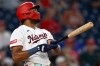 Washington Nationals' James Wood watches his grand slam go over the center field fence during the fifth inning of a baseball game against the Houston Astros, Monday, July 6, 2026, in Washington. (AP Photo/John McDonnell)