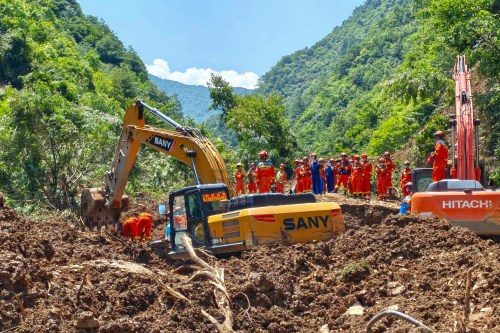 In this photo released by Xinhua News Agency, rescuers conduct search and rescue at the site of a landslide at a village in Nanhe township of Tanchang County, Longnan City, northwest China's Gansu Province on Tuesday, July 7, 2026. (Xinhua via AP)