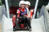 Canada's Beattie Podulsky, left, and Kailey Allan, right, arrive at the finish during a women's doubles luge run at the 2026 Winter Olympics, in Cortina d'Ampezzo, Italy, Wednesday, Feb. 11, 2026. (AP Photo/Aijaz Rahi)