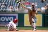 Washington Nationals' Drew Millas is out at second base as Pittsburgh Pirates shortstop Konnor Griffin throws to first base to put out Nationals' Nasim Nunez during the seventh inning of a baseball game, Saturday, July 4, 2026, in Washington. (AP Photo/Nick Wass)