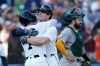 Detroit Tigers' Colt Keith celebrates his two-run home run with Kevin McGonigle (7) after crossing the plate past Athletics catcher Shea Langeliers, right, during the first inning of a baseball game Tuesday, July 7, 2026, in Detroit. (AP Photo/Duane Burleson)
