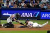 Los Angeles Dodgers' Dalton Rushing, right, is tagged out by Colorado Rockies catcher Braxton Fulford as he tries to score on a fielder's choice bunt by Miguel Rojas during the fifth inning of a baseball game Tuesday, July 7, 2026, in Los Angeles. (AP Photo/Mark J. Terrill)