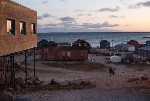 The federal government is expected to announce Wednesday that it will begin the process to designate two key Arctic projects as projects of national interest. Residents walk down the hill to their home in the town of Gjoa Haven, Nunavut, on Friday Sept. 1, 2017. THE CANADIAN PRESS/Jason Franson