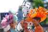 Racegoers pose for photographers as they arrive on the second day of the Royal Ascot horse race meeting in Ascot, England, Wednesday, June 17, 2026. (AP Photo/Alastair Grant)