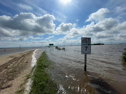 Flooding overtook Provincial Road 323 at Highway 7 Wednesday, with a sinkhole about half a kilometre away. (Ruth Bonneville / Free Press)