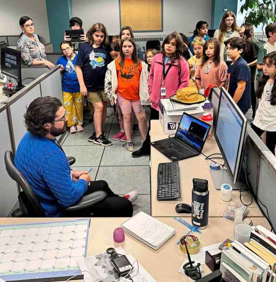 Earl Grey students talk to reporter Tyler Searle in the newsroom. (Free Press)