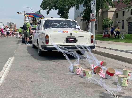 Academy Hospitality decked out a vintage car for its Pride float to celebrate the marriage of Mira Kopiova and Jamie Komarniski who were grand marshals for the parade. (Maggie Macintosh / Free Press)