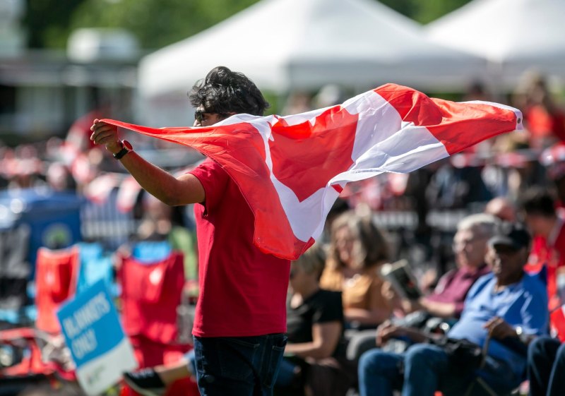 BROOK JONES/FREE PRESS
The Assiniboine Park Conservancy hosts an outdoor watch party of the 2026 FIFA World Cup match between Canada and Qatar on a  giant screen at the Lyric Theatre at Assiniboine Park in Winnipeg, Man., Thursday, June 18, 2026. Tapan Patel, 27,  is pictured with a Canadian flag while attending the watch party.