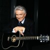 Tommy Hunter poses with a guitar in an undated handout photo. Hunter, who was known by fans as 