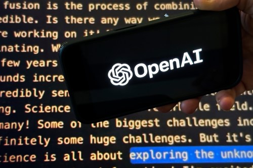 The OpenAI logo appears on a mobile phone in front of a screen showing part of the company website in this photo taken on Nov. 21, 2023 in New York. THE CANADIAN PRESS/AP-Peter Morgan