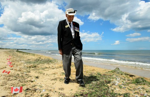 Veteran of the Second World War Bill Wilson walks on Juno Beach after the D-Day 75th Anniversary Canadian National Commemorative Ceremony at Juno Beach in Courseulles-sur-Mer, France, on Thursday, June 6, 2019. THE CANADIAN PRESS/Sean Kilpatrick