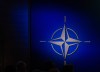 The NATO logo is illuminated beside the stage during a ceremony celebrating the alliance's 75th anniversary in Washington, D.C., on Tuesday, July 9, 2024. THE CANADIAN PRESS/Adrian Wyld